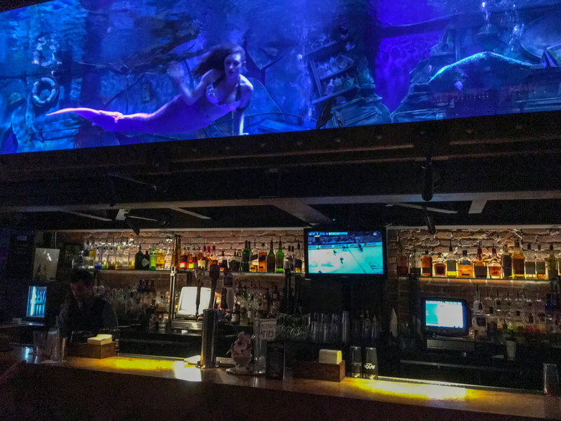 Live Mermaids in Dive Bar / Spain's Rebounding Social Life 2021 / Karen McCann / EnjoyLivingAbroad.com
